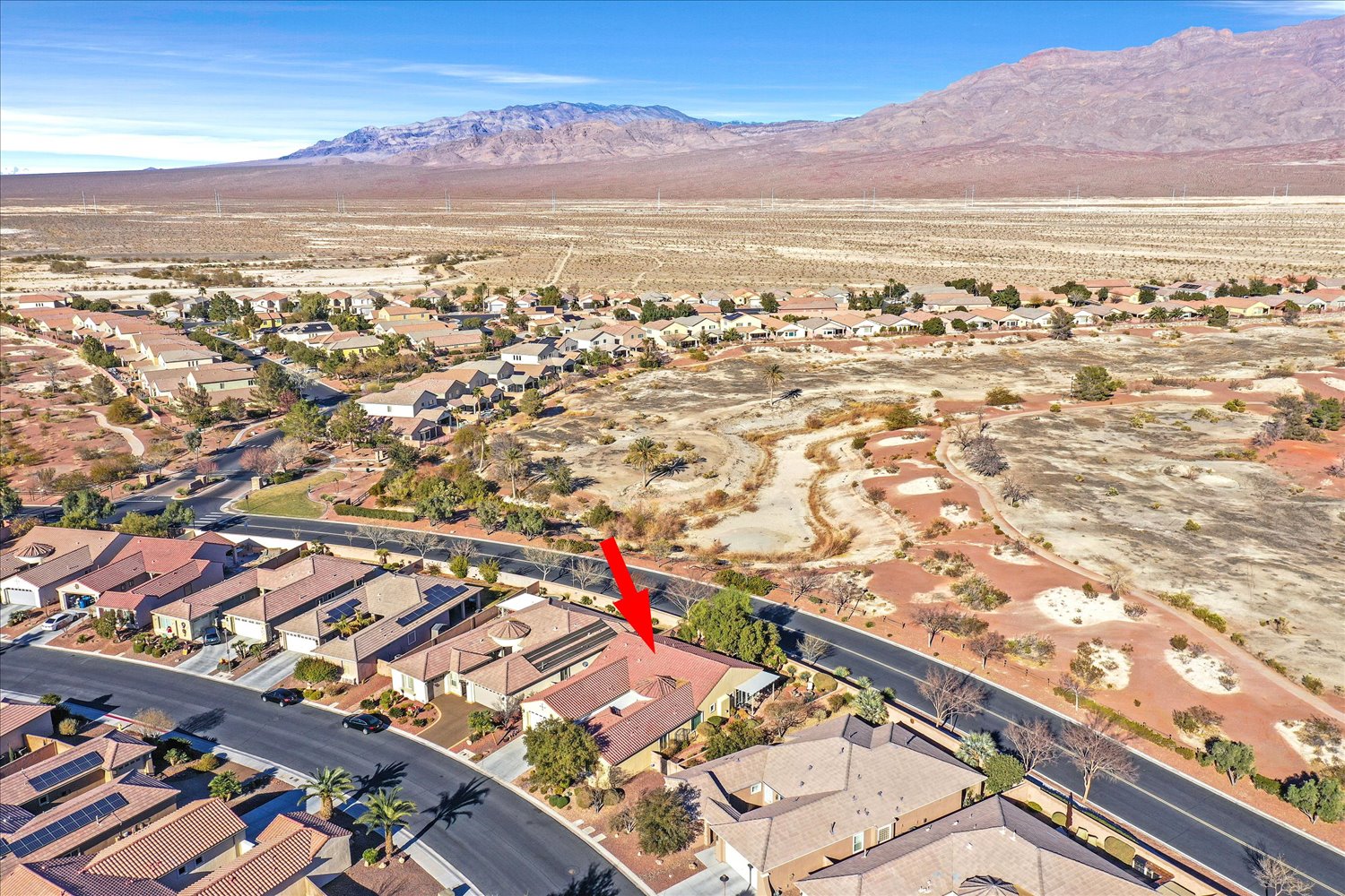 Aerial capturing backyard adjacent to desert trails and open space