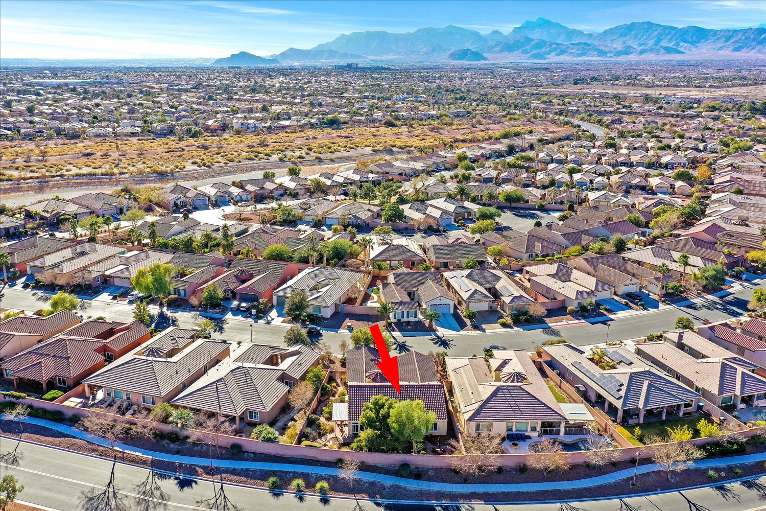 Aerial view emphasizing nearby mountain range and community layout