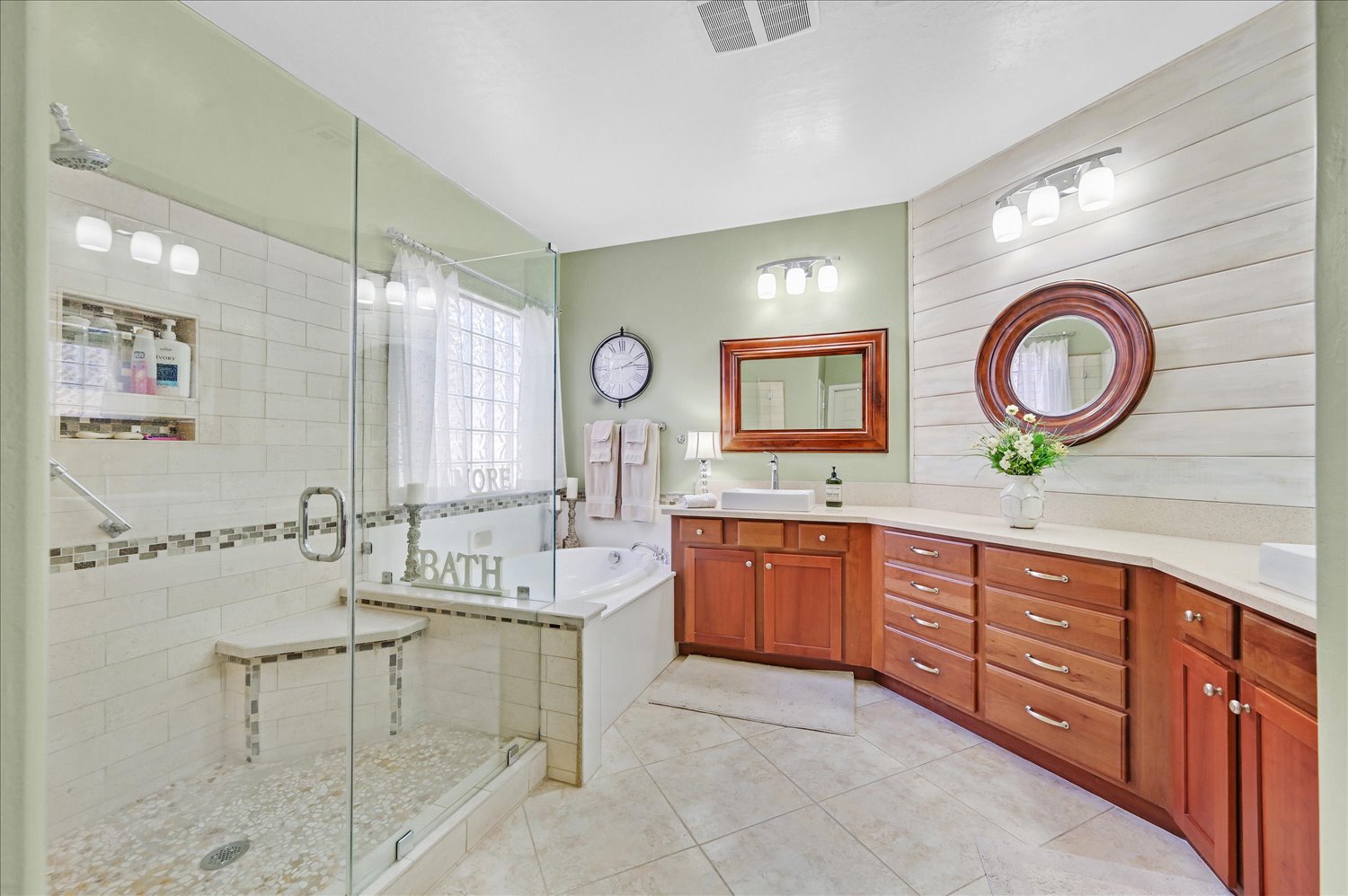 Kitchen island featuring double ovens and custom cabinetry