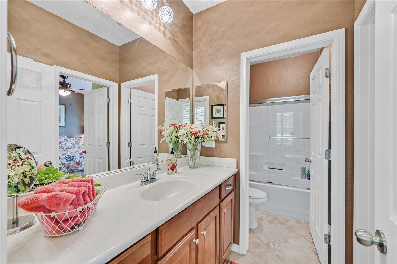 Side-yard walkway framed by lush plantings and privacy wall